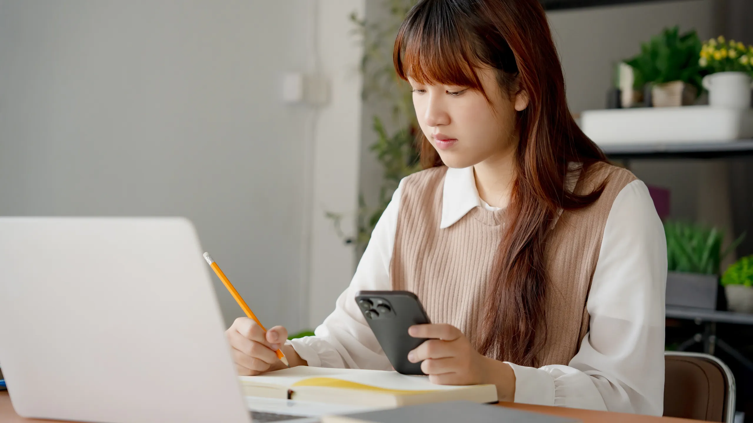 Asian girl student doing exam hand holding pencil writing answer in university classroom education high school or university student taking notes while preparing for exam