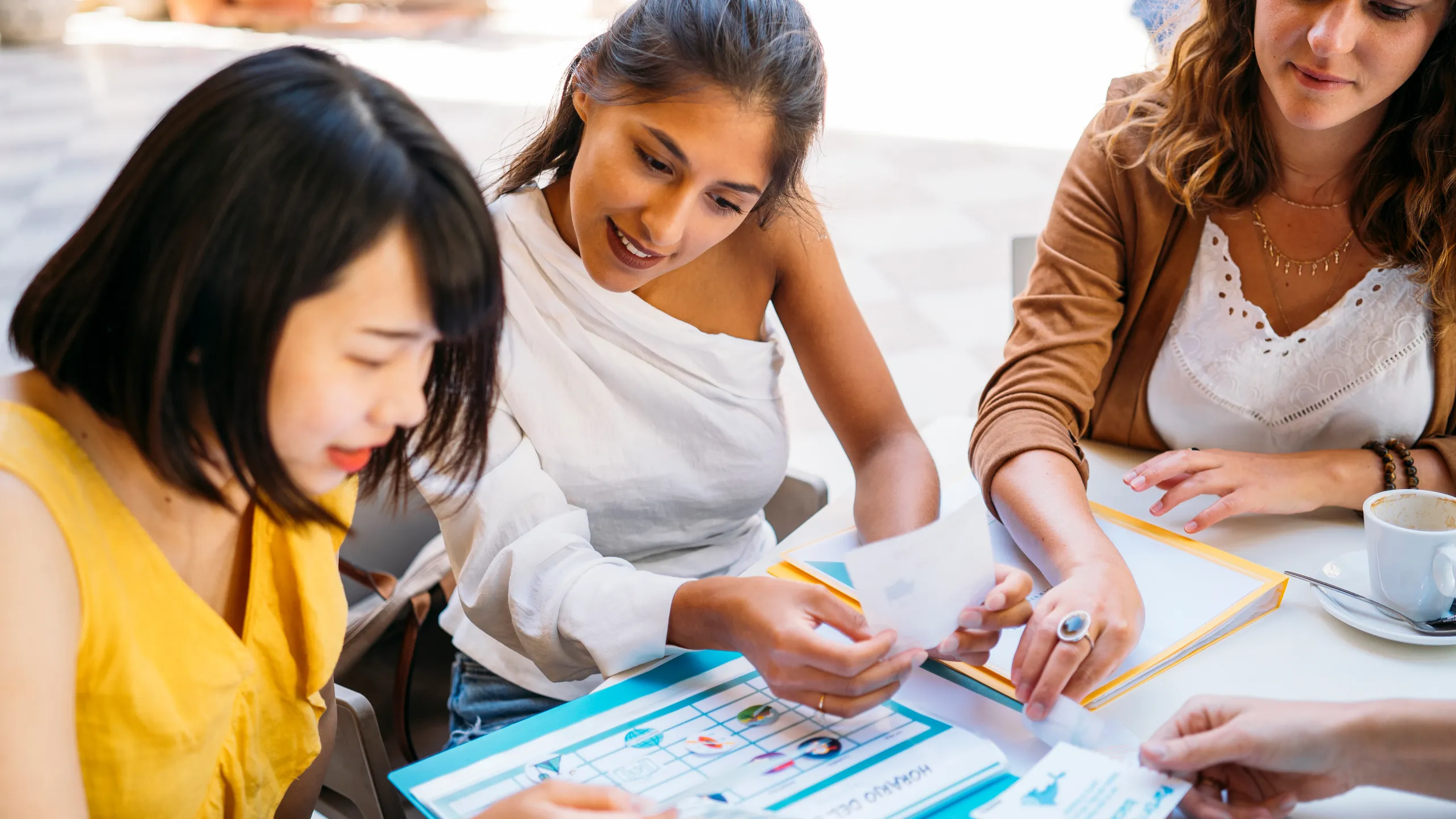 University exchange students organizing schedule at outdoor cafe