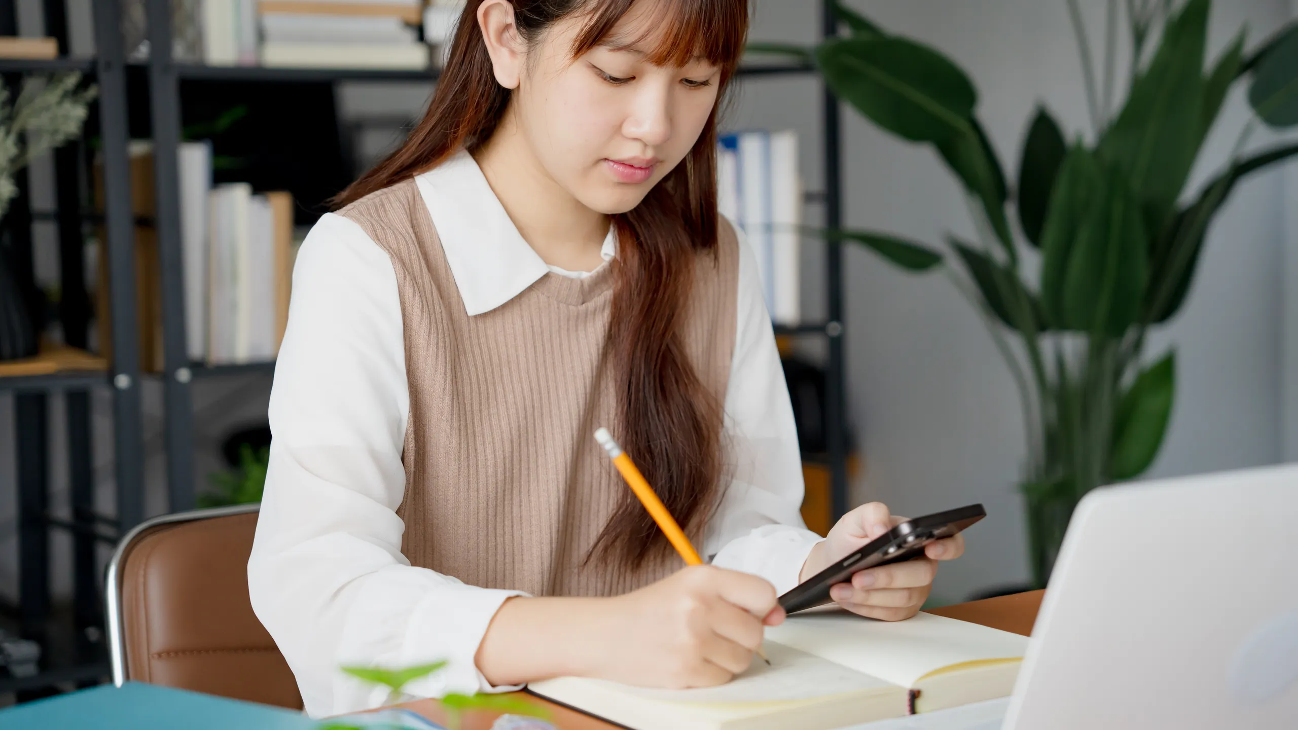 Asian girl student doing exam hand holding pencil writing answer in university classroom education high school or university student taking notes while preparing for exam