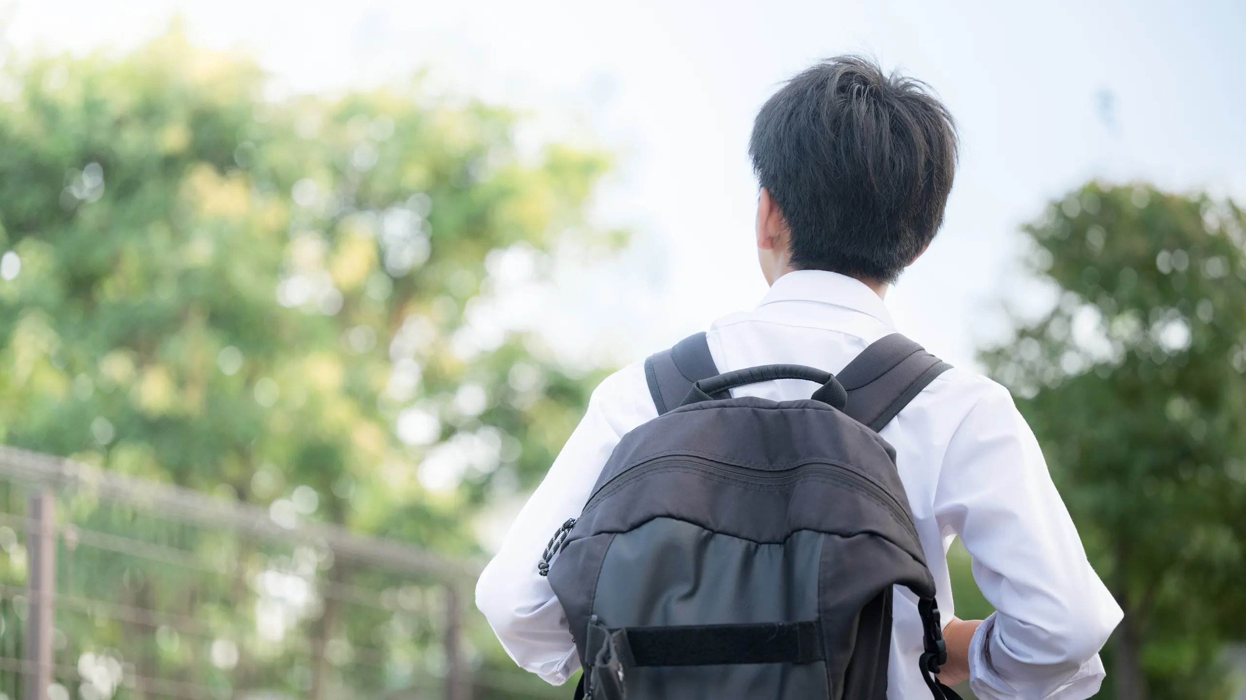 High school student with backpack walking