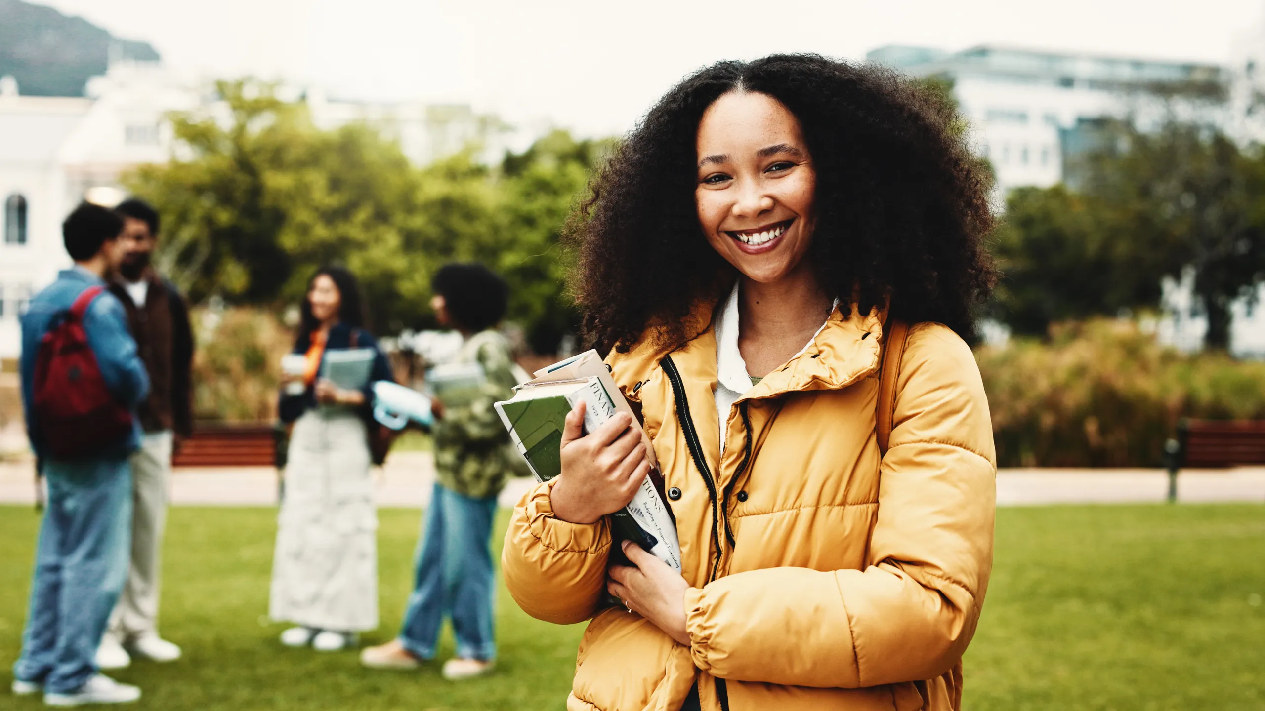 Portrait, student or woman on campus with textbook for college scholarship, education or english degree. Happy, person outdoor or books at university for literature study, knowledge or academic goals