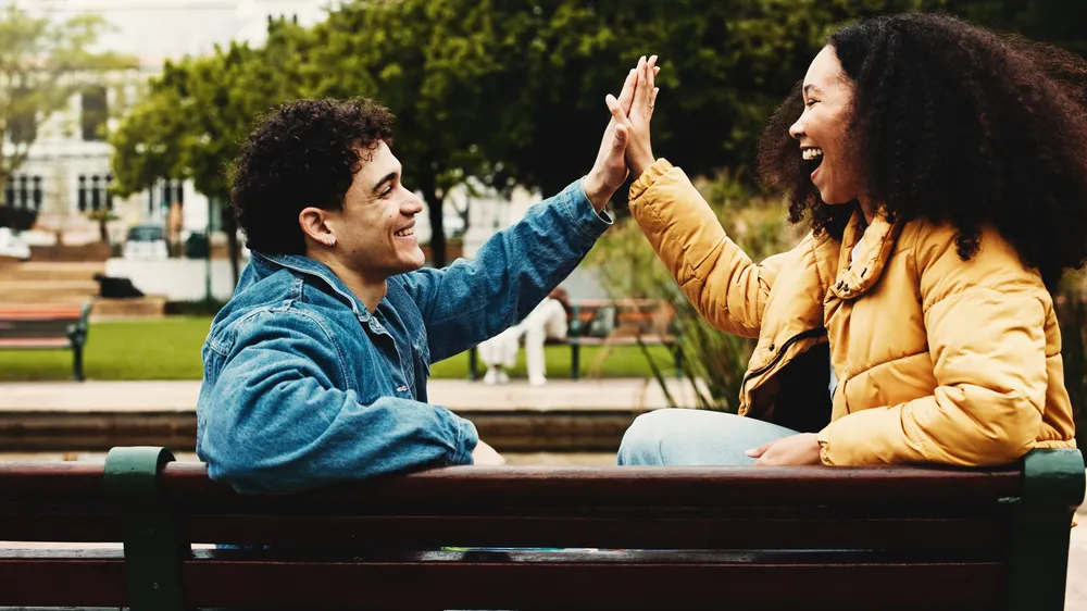 Happy, college students or high five on campus for success, scholarship opportunity or degree choice. People outdoor, celebration or smile in university for skill development, study or learning goals