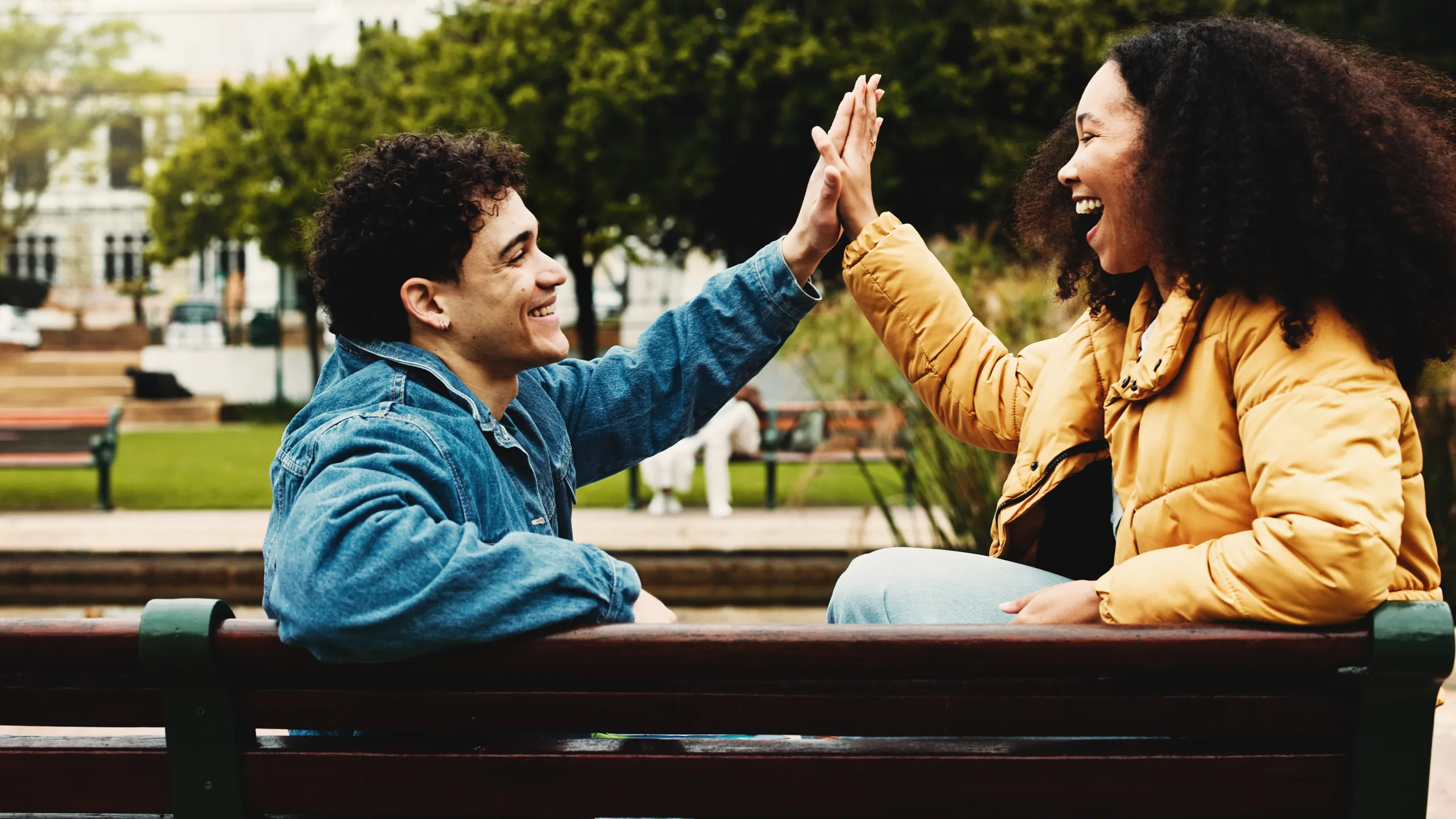 Happy, college students or high five on campus for success, scholarship opportunity or degree choice. People outdoor, celebration or smile in university for skill development, study or learning goals