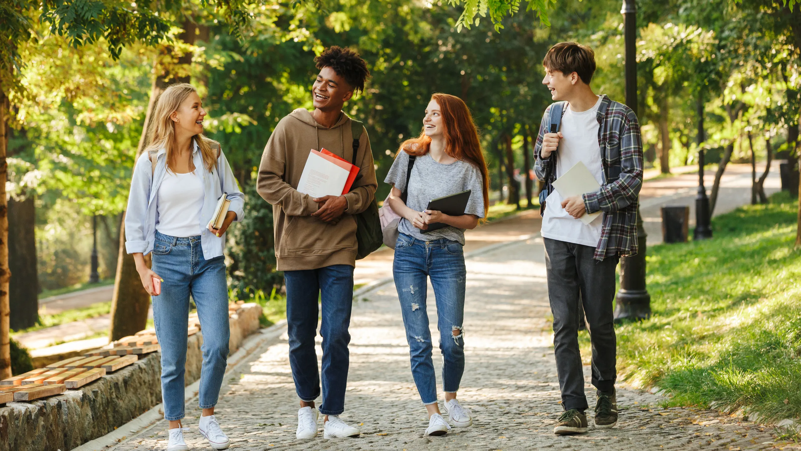 Group of happy students walking at the campus