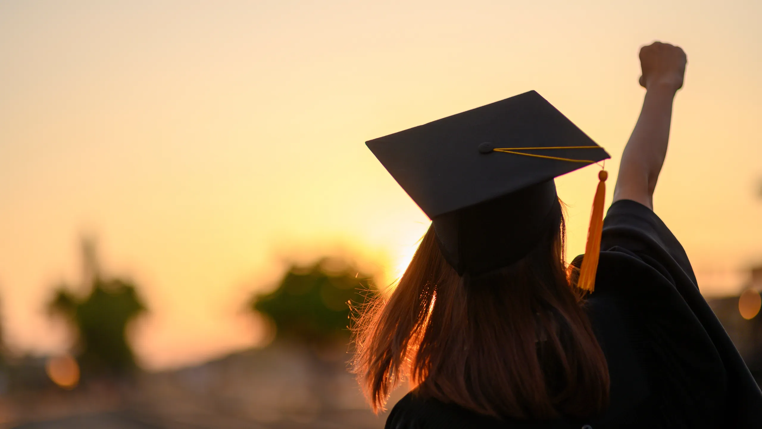 Graduates wear a black dress, black hat at the university level.