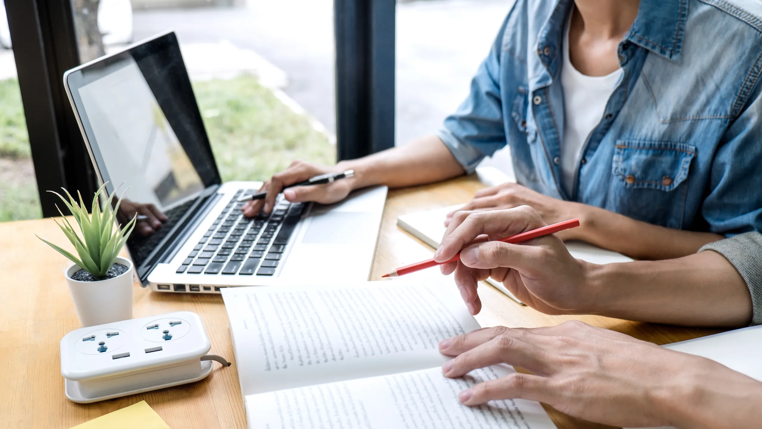 Education, teaching, learning concept. High school students or classmates group tutor in library studying and reading with helps friend doing homework and lesson practice preparing exam to entrance