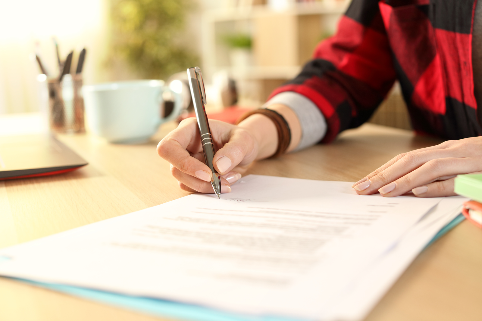 Student signing grant paperwork