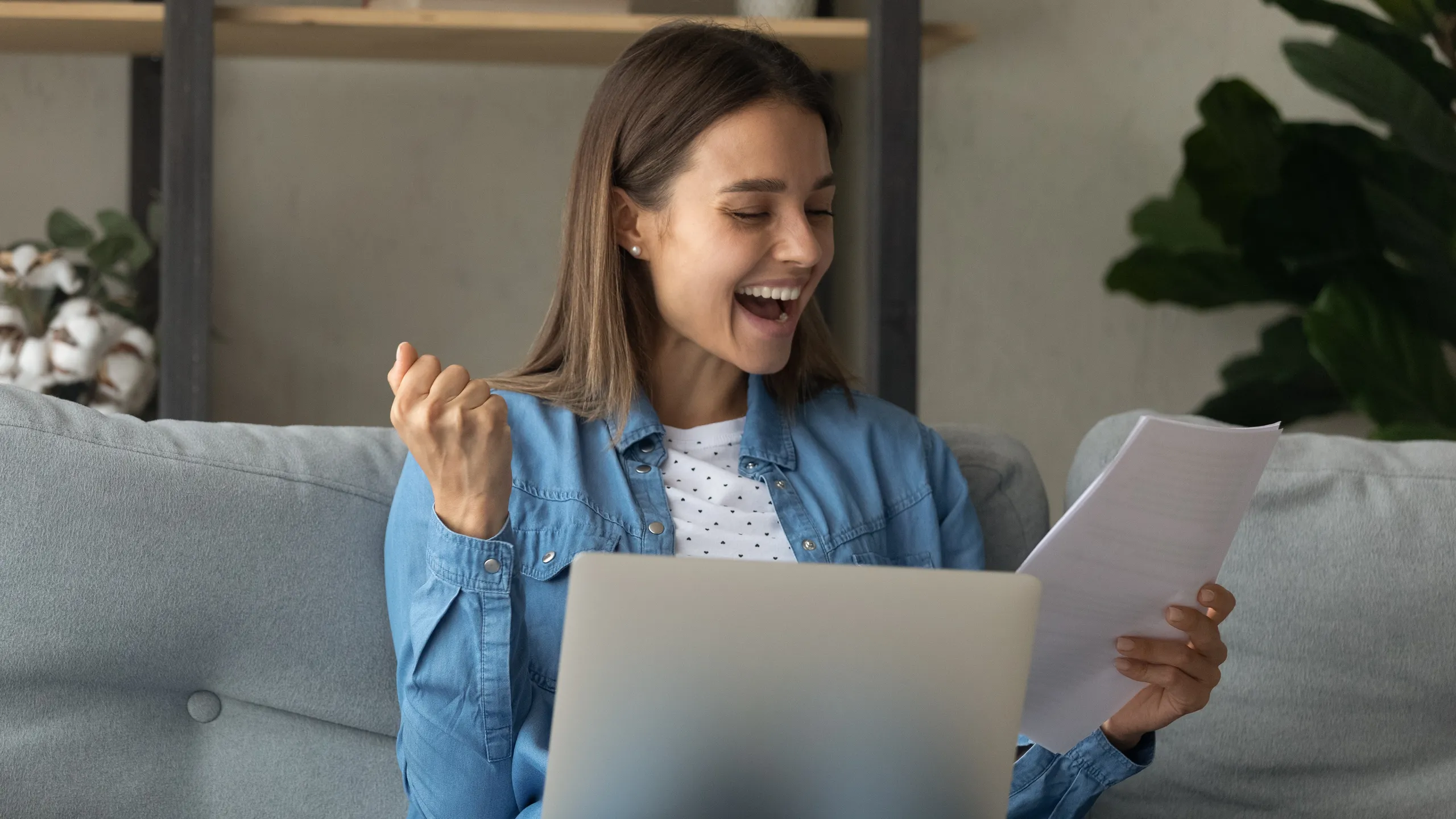 Close up overjoyed woman reading good news in paper letter