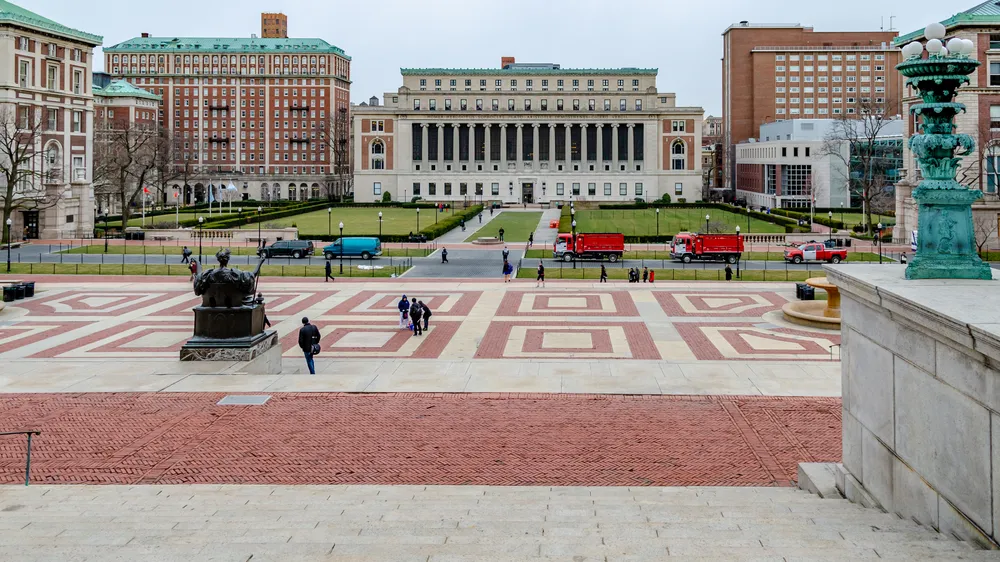 Aerial view of the Columbia University, view from the Library of Columbia University, Staircase in the forefront, Park with meadow and Students in the background, New York City, during winter day with