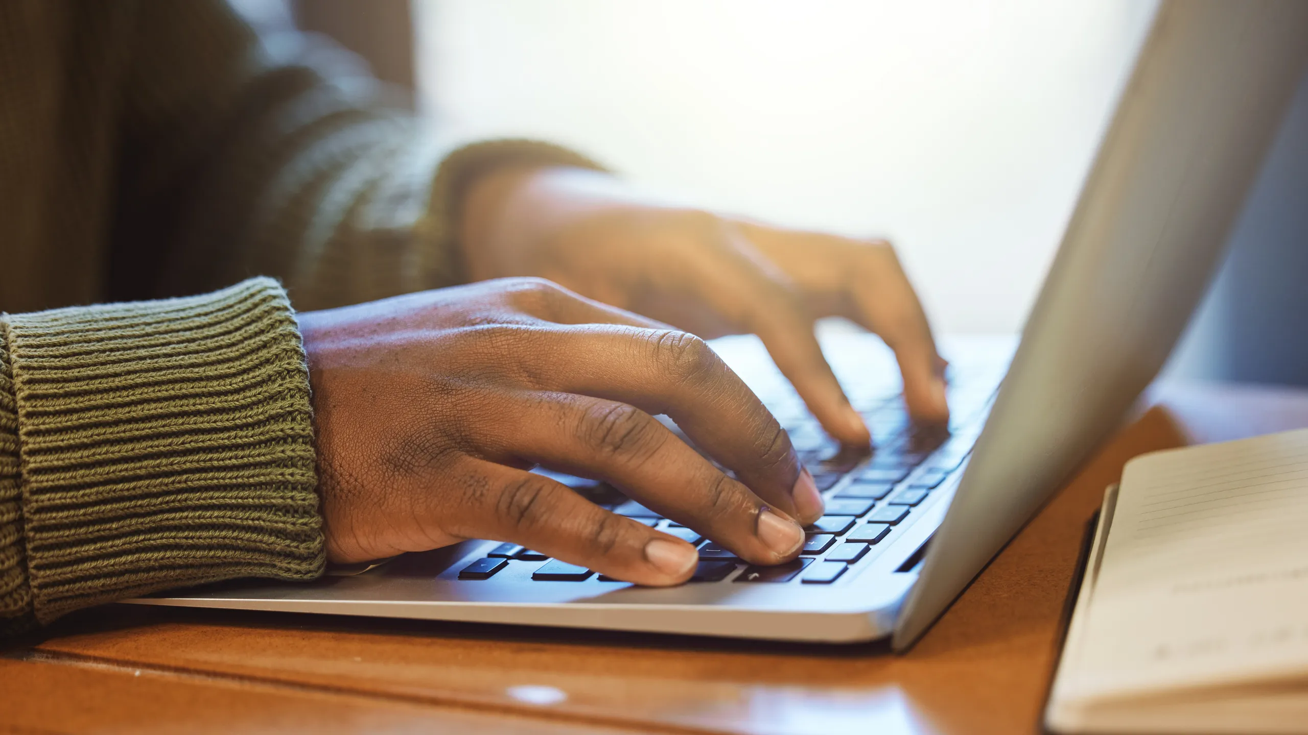 Laptop, hands and typing, student and education with report or essay writing, studying for exam for university. Scholarship, college student working closeup and proposal, keyboard with email and wifi