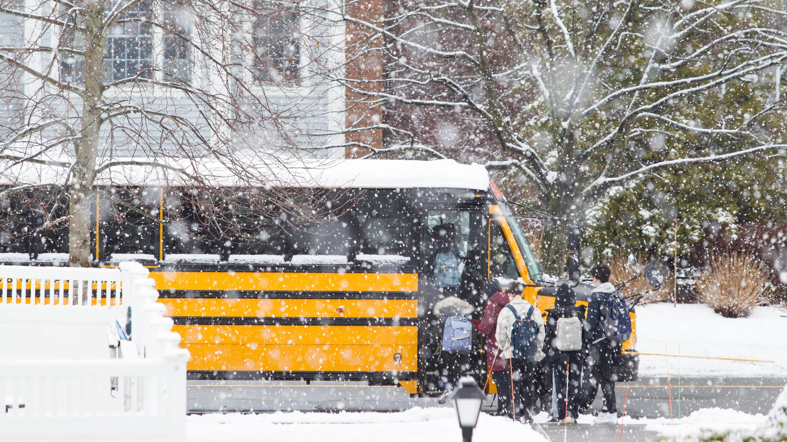 High School Students are Boarding School Bus in Blizzard Snow Storm at Lexington, MA on January 20, 2023
