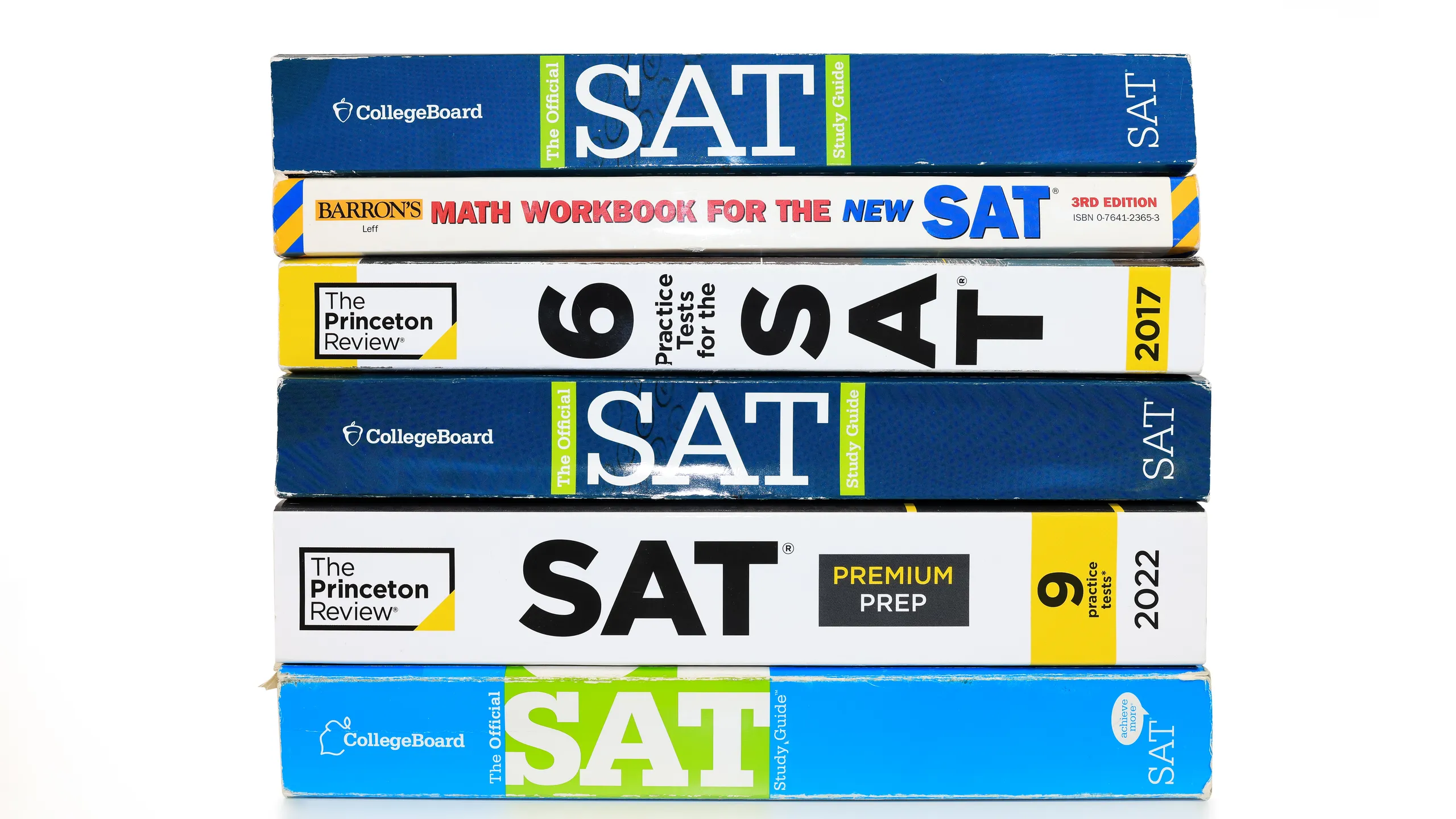 Stack of SAT books contain standardized practice tests for university admissions in USA.