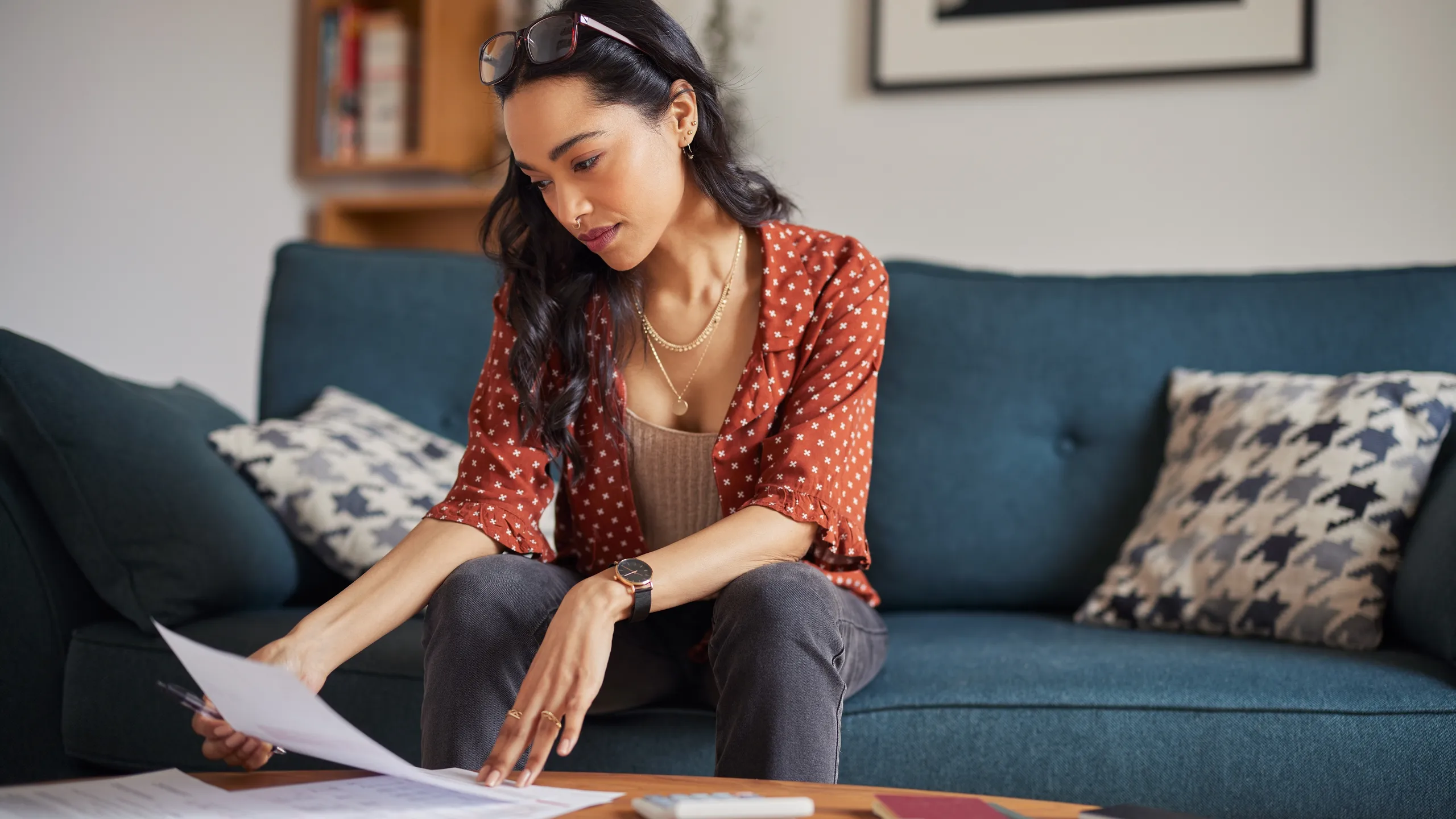 Woman reading bills at home