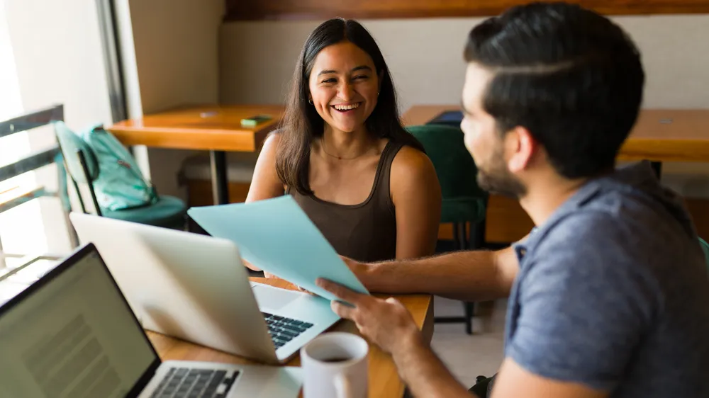 Cheerful woman and man working as a teamwork