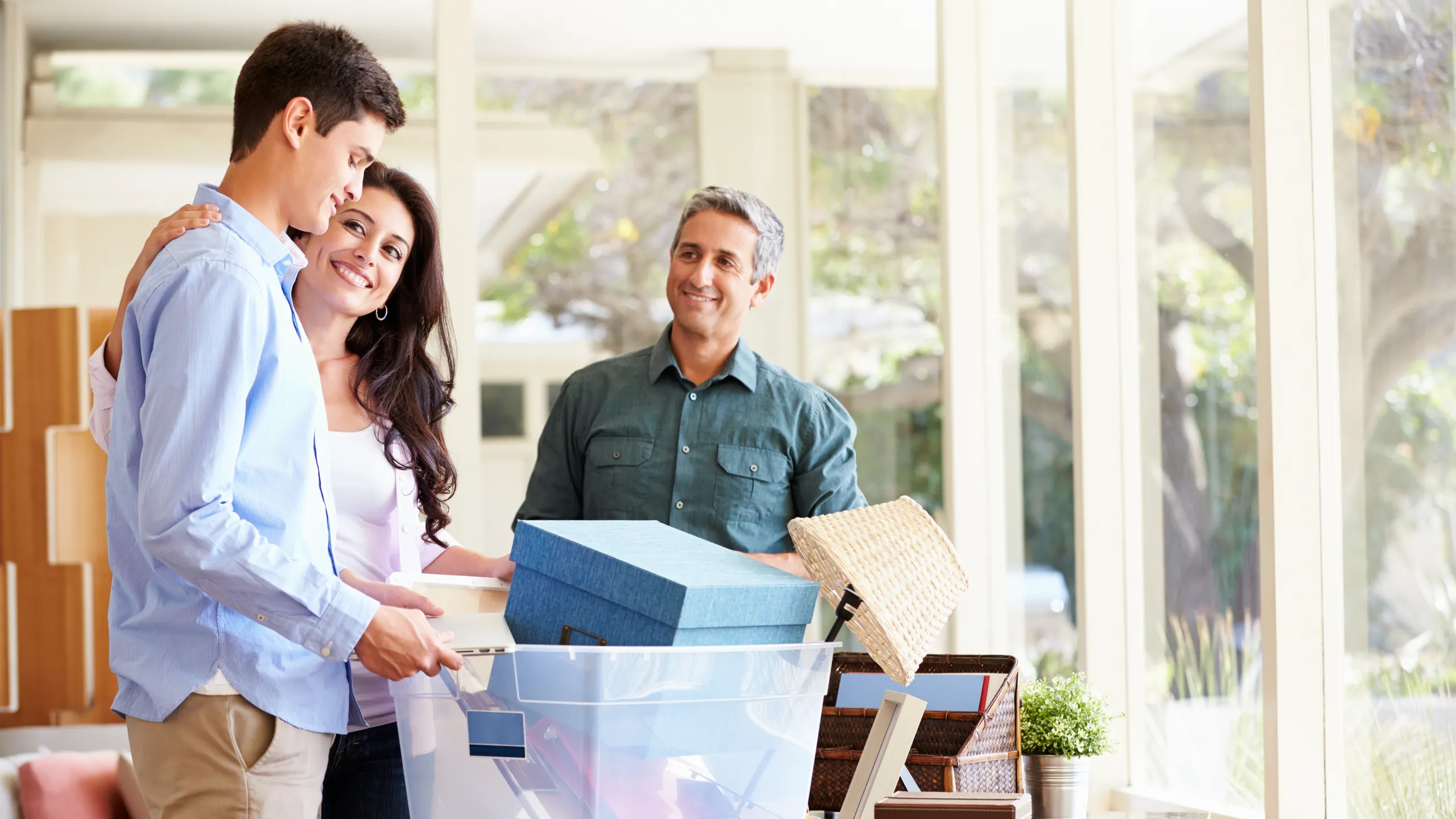Parents Helping Teenage Son Pack For College