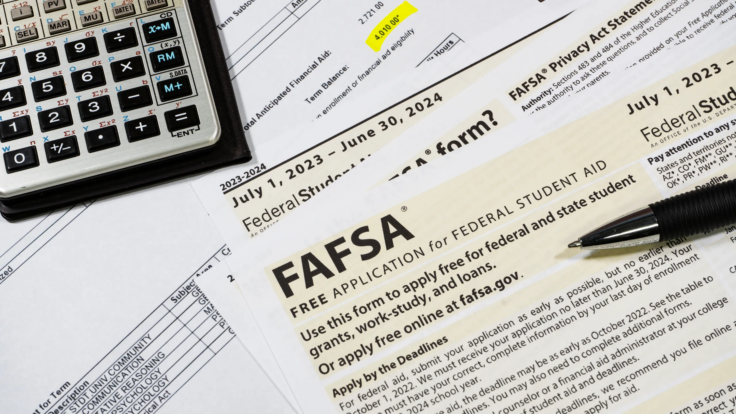 Close up of federal financial aid application with calculator