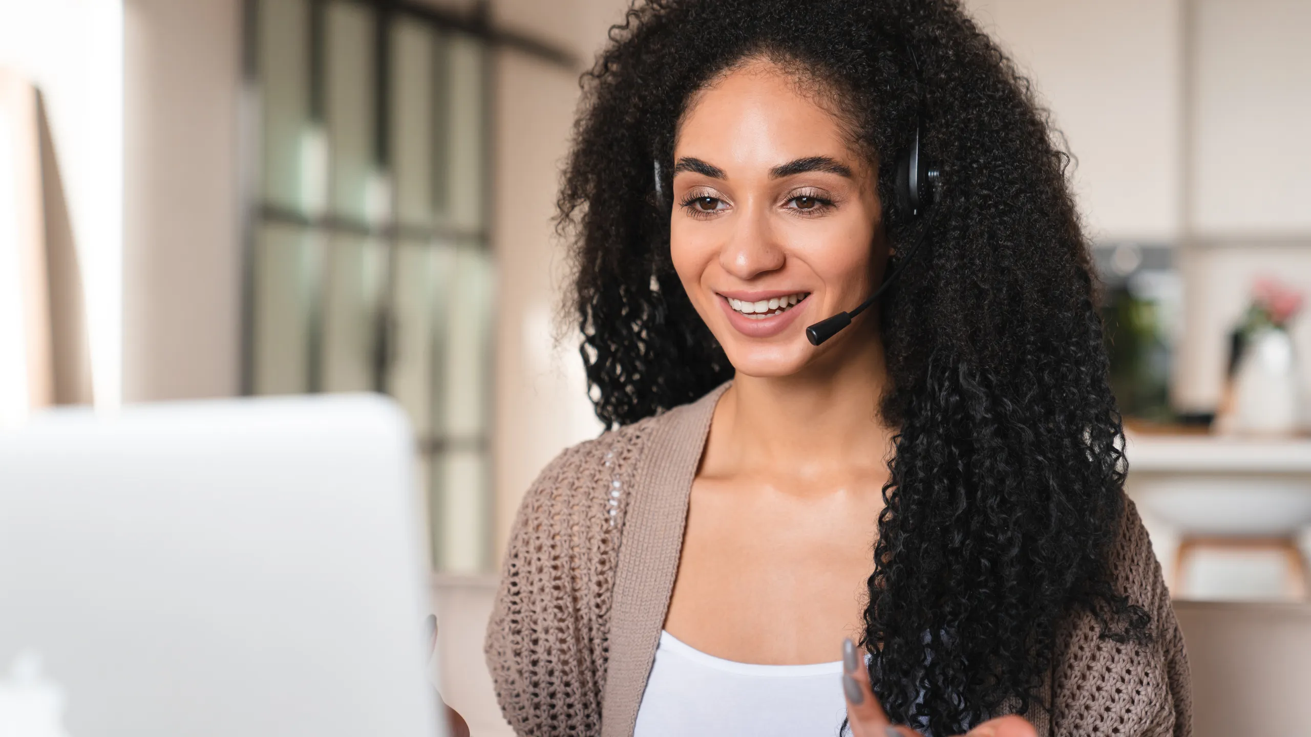 Remote worker seller, hotline agent, customer support manager. Tutor having e-lesson e-learning online from laptop wearing headset. Web conference, videocall