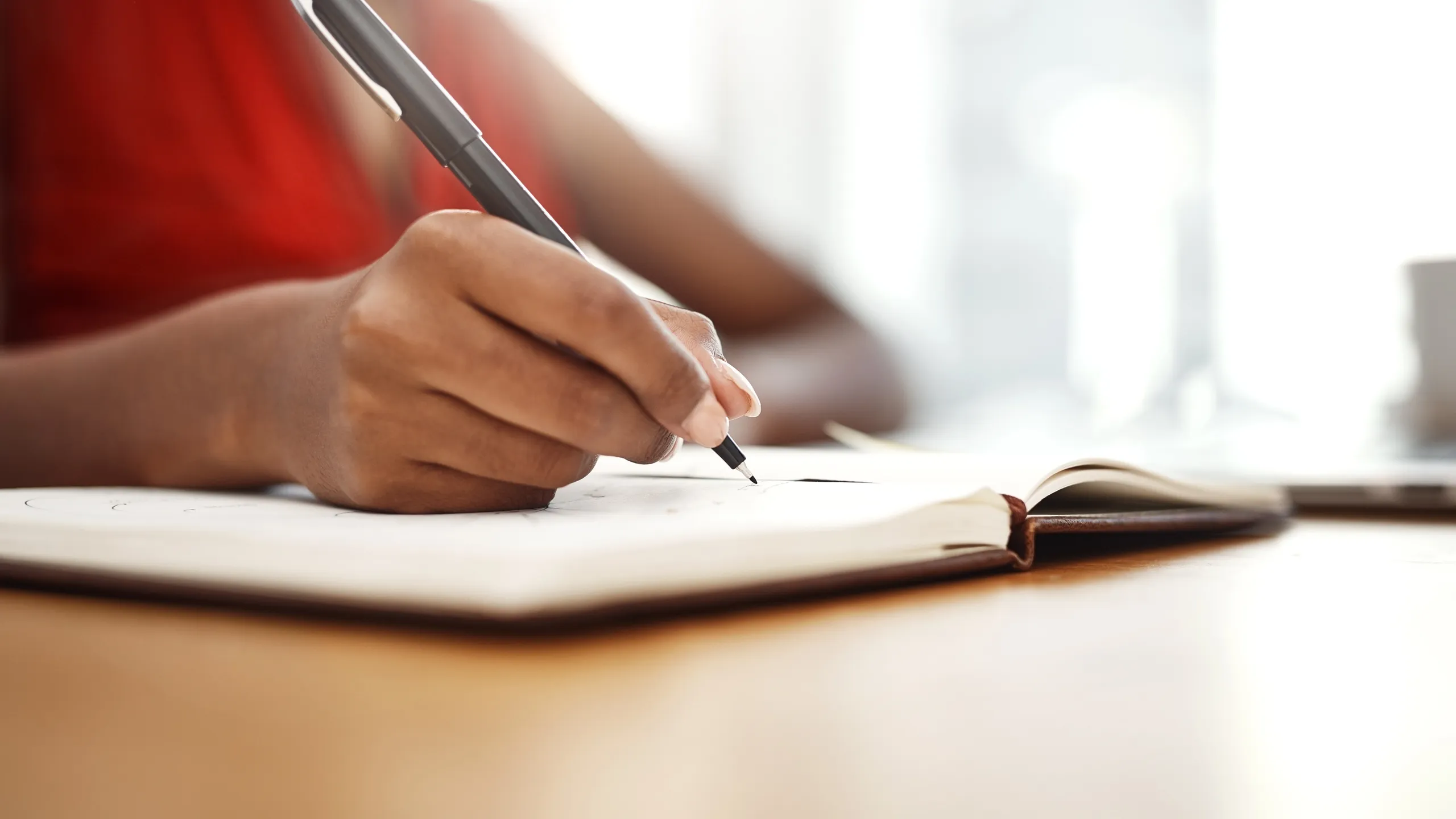 Hands, writing and notes of ideas in planner with schedule for university, research or class. Person, planning and reminder in calendar with deadline info or creative solution to college project
