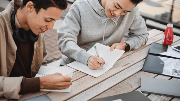 College Essay Coach 1 - students writing essays at a table