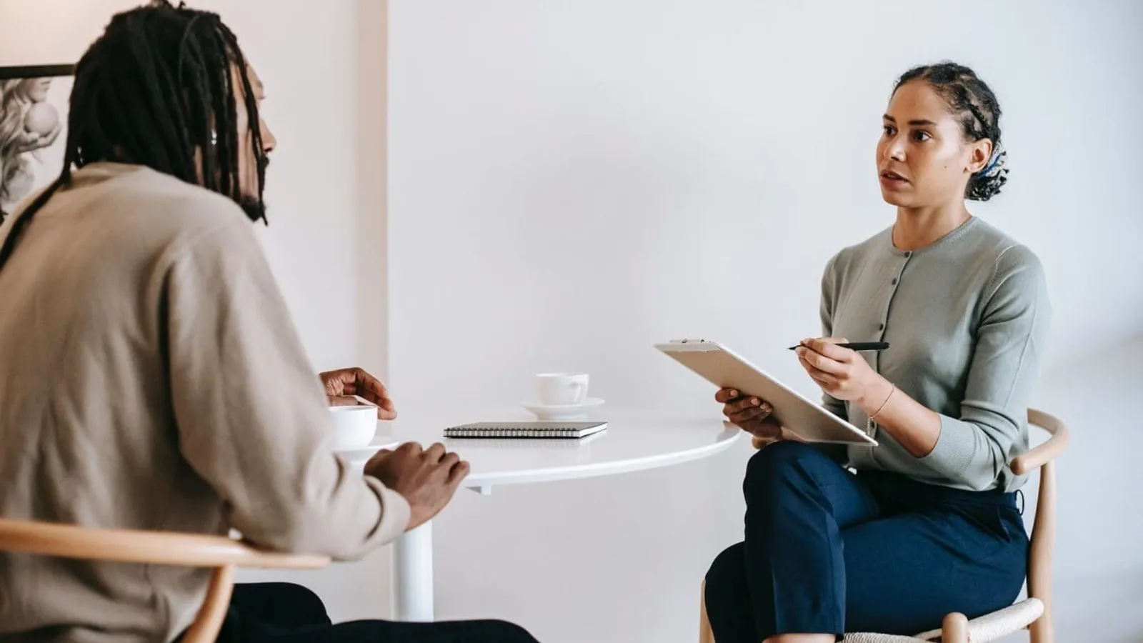 ethnic female psychotherapist listening to black clients explanation