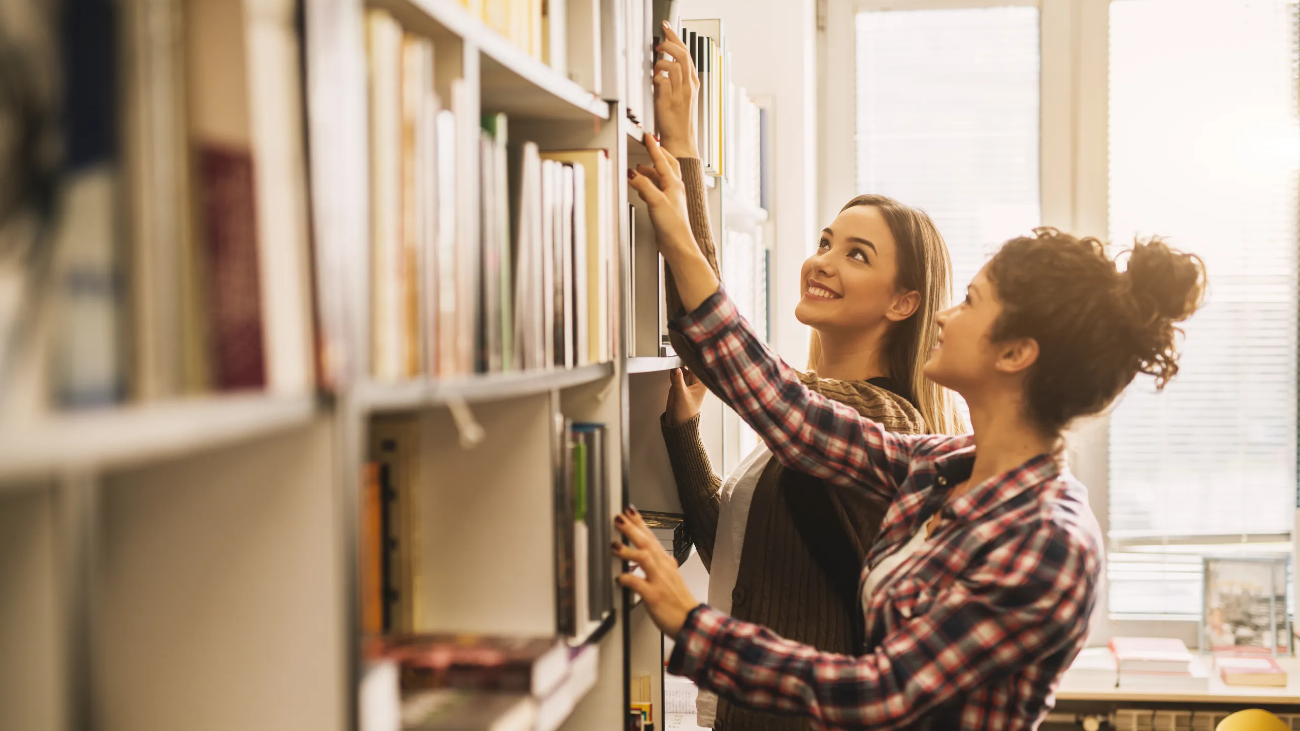 students at library picking out books