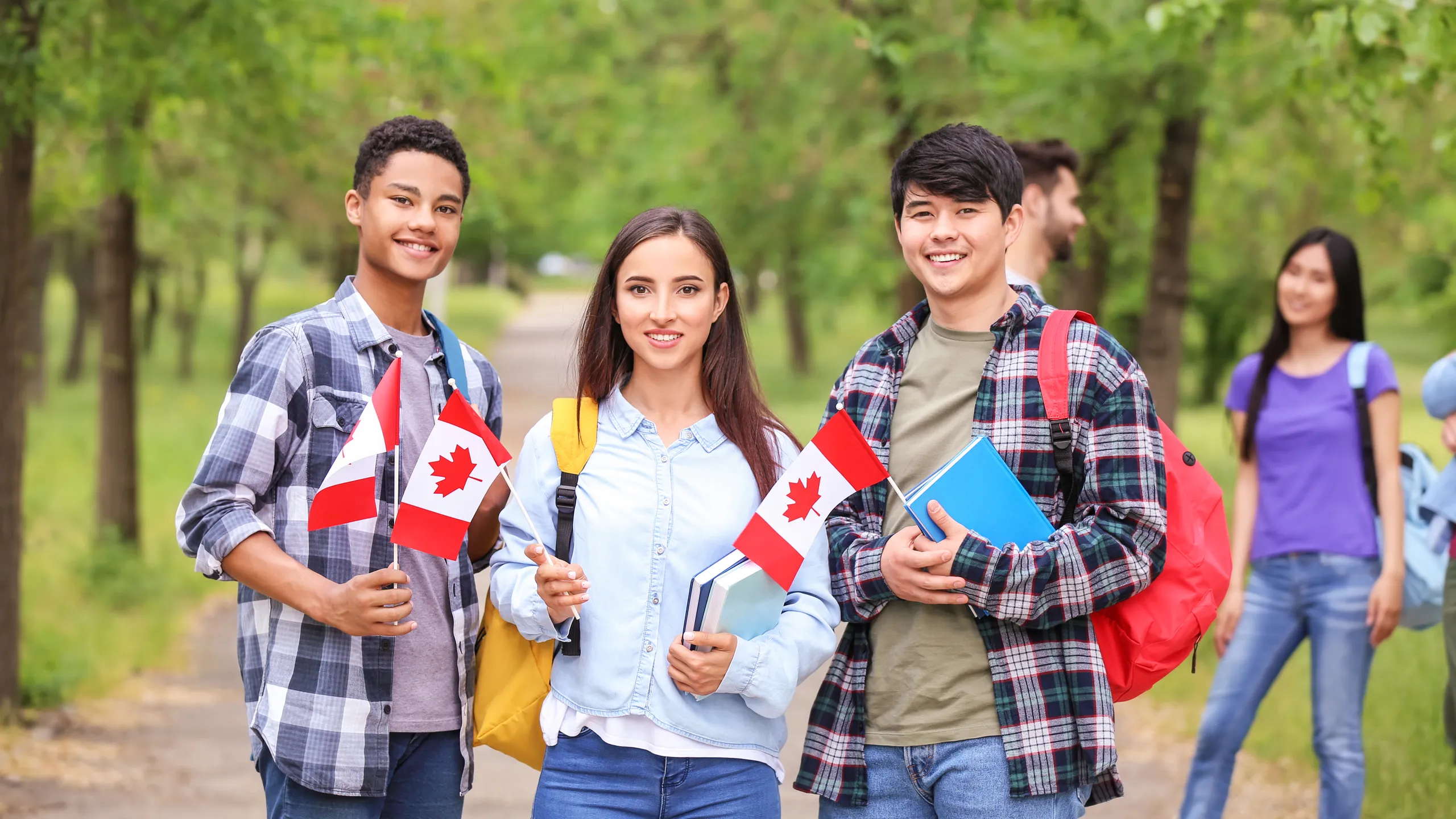 students holding Canadian flags