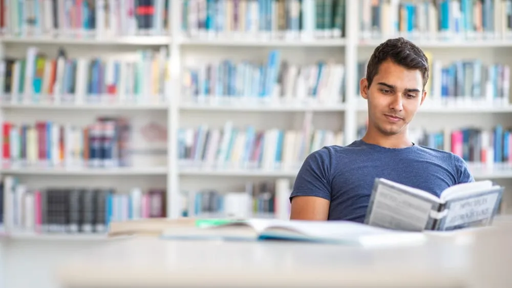 student reading in the library