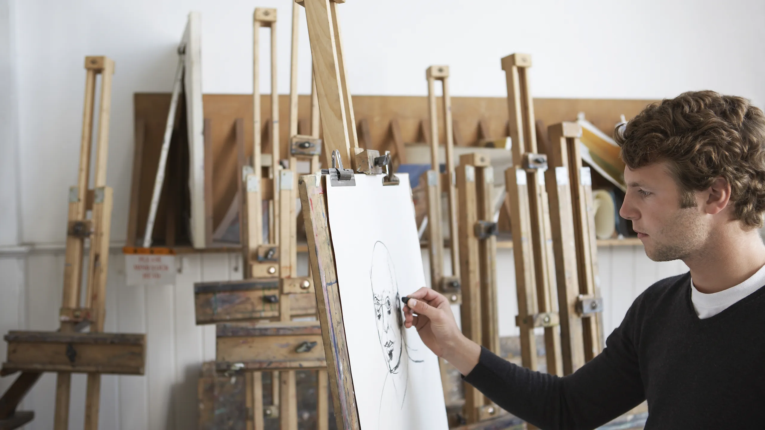 artist is drawing on canvas
