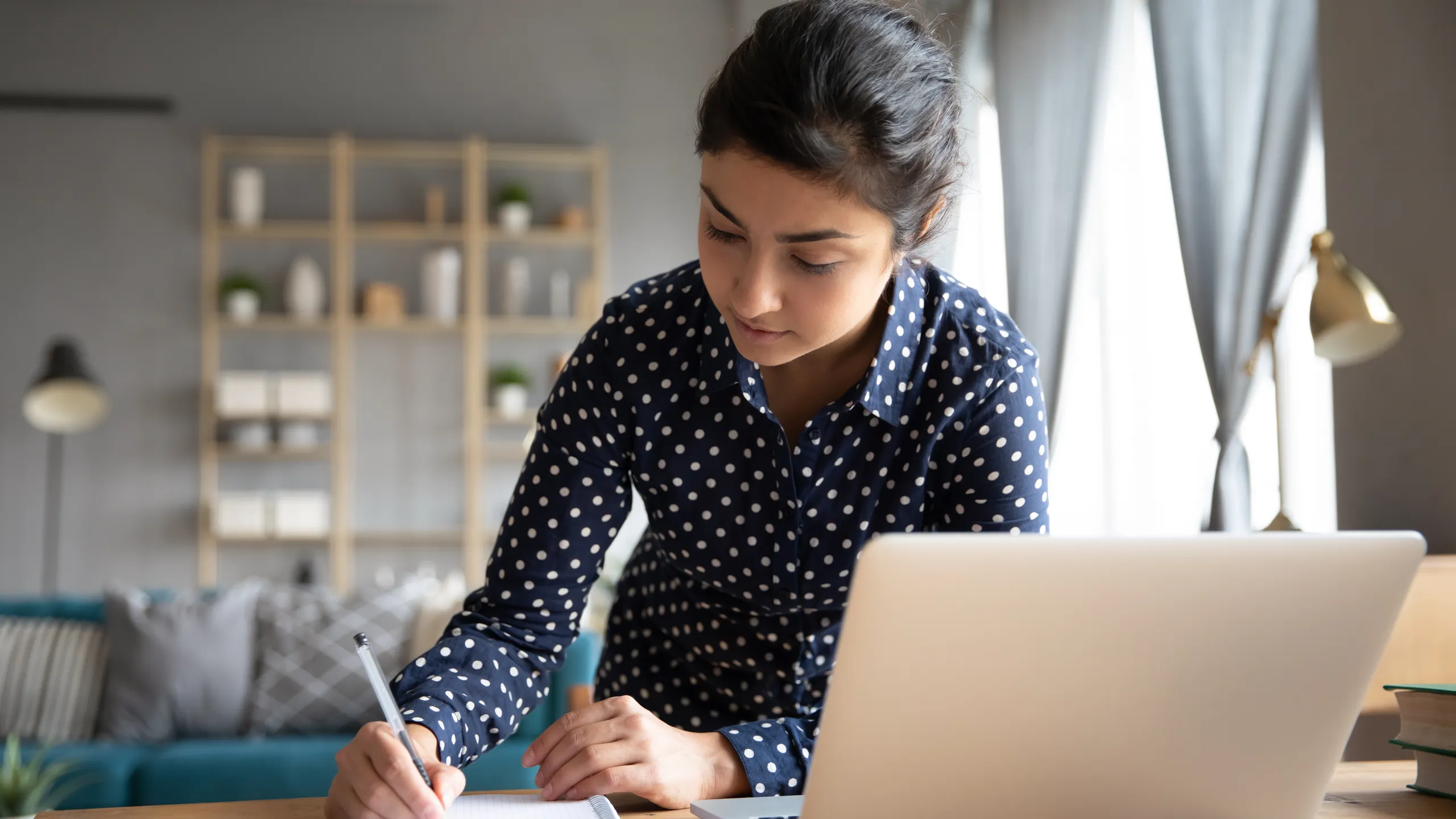 student taking notes at home