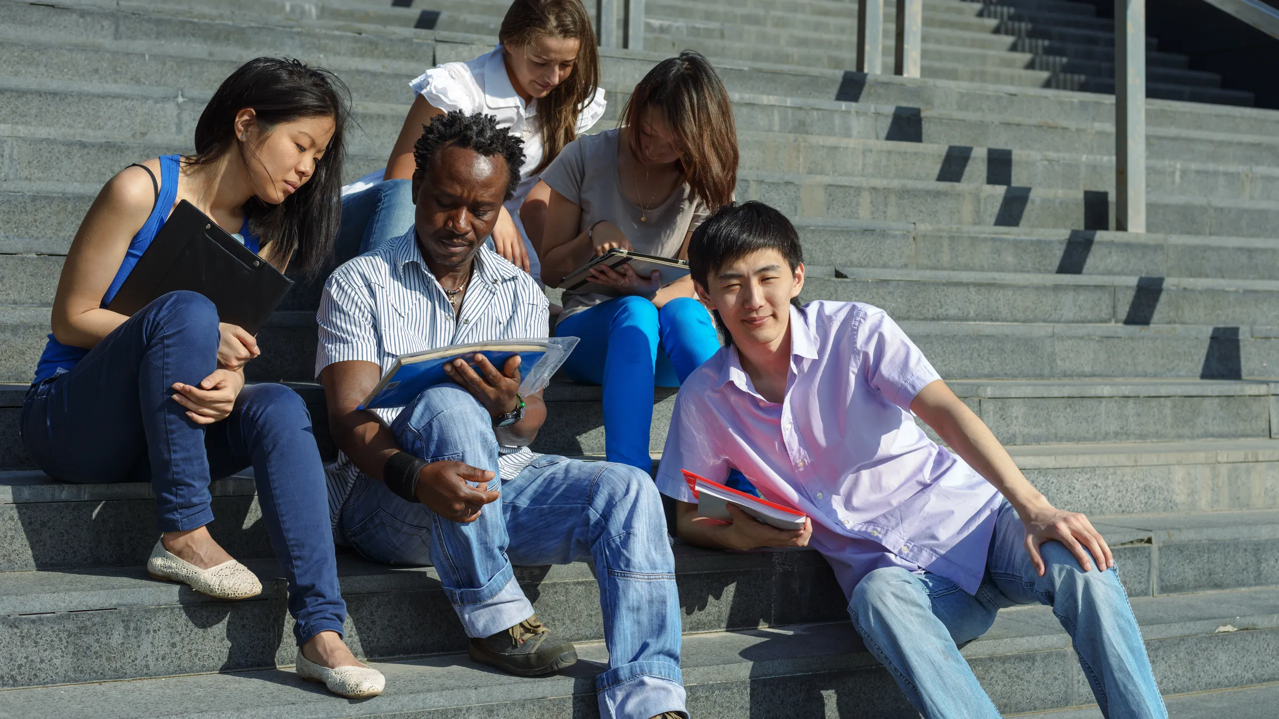 students sitting on staircase