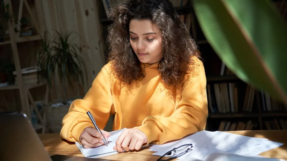 student writing college essay