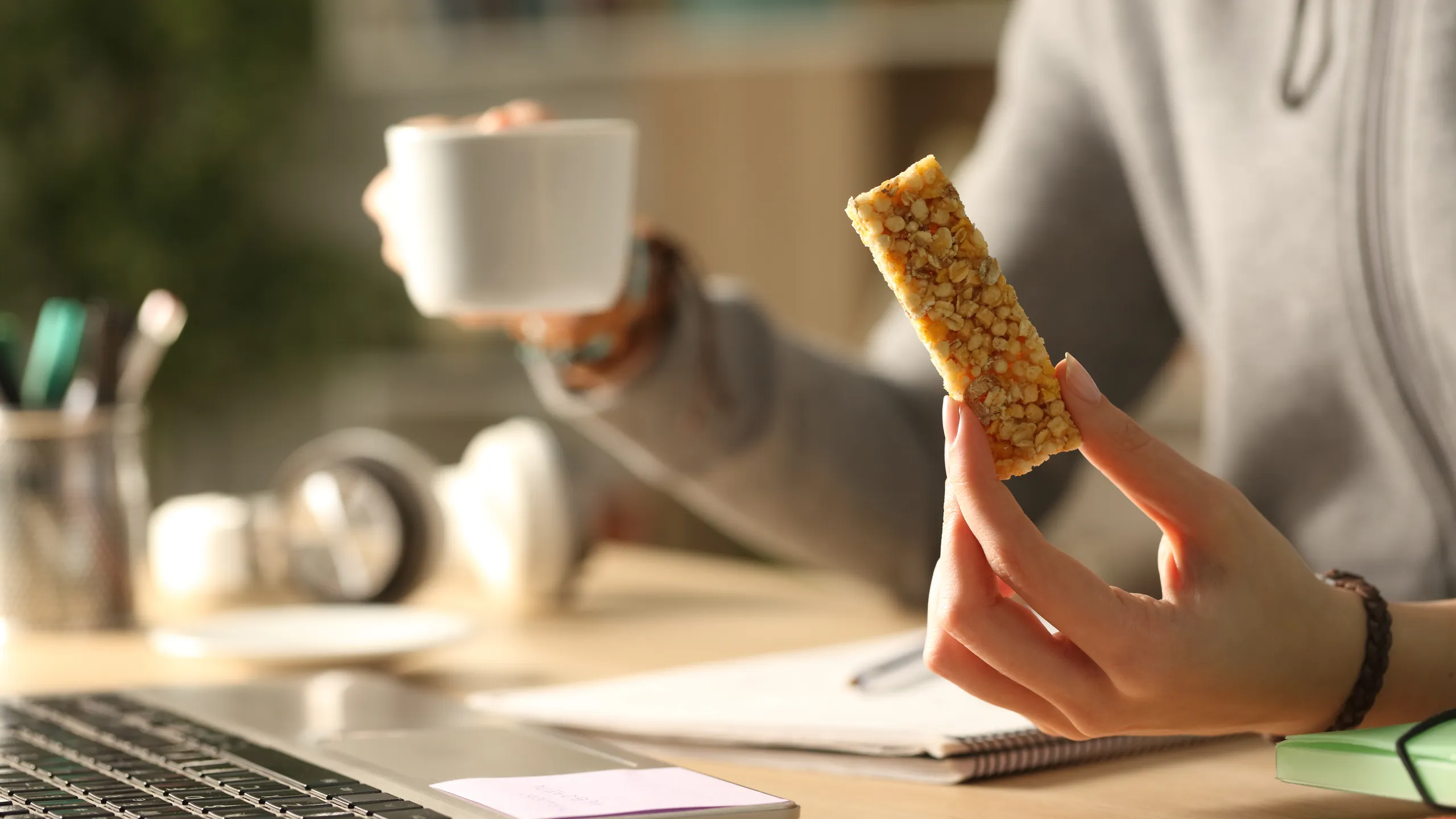 student holding a coffee and snack