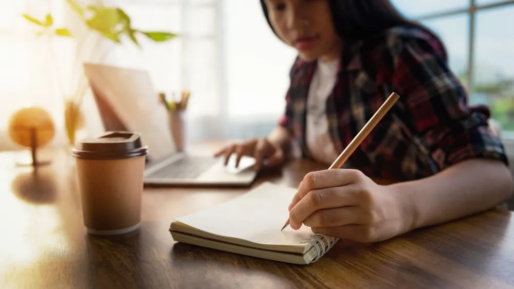 students taking notes on desk