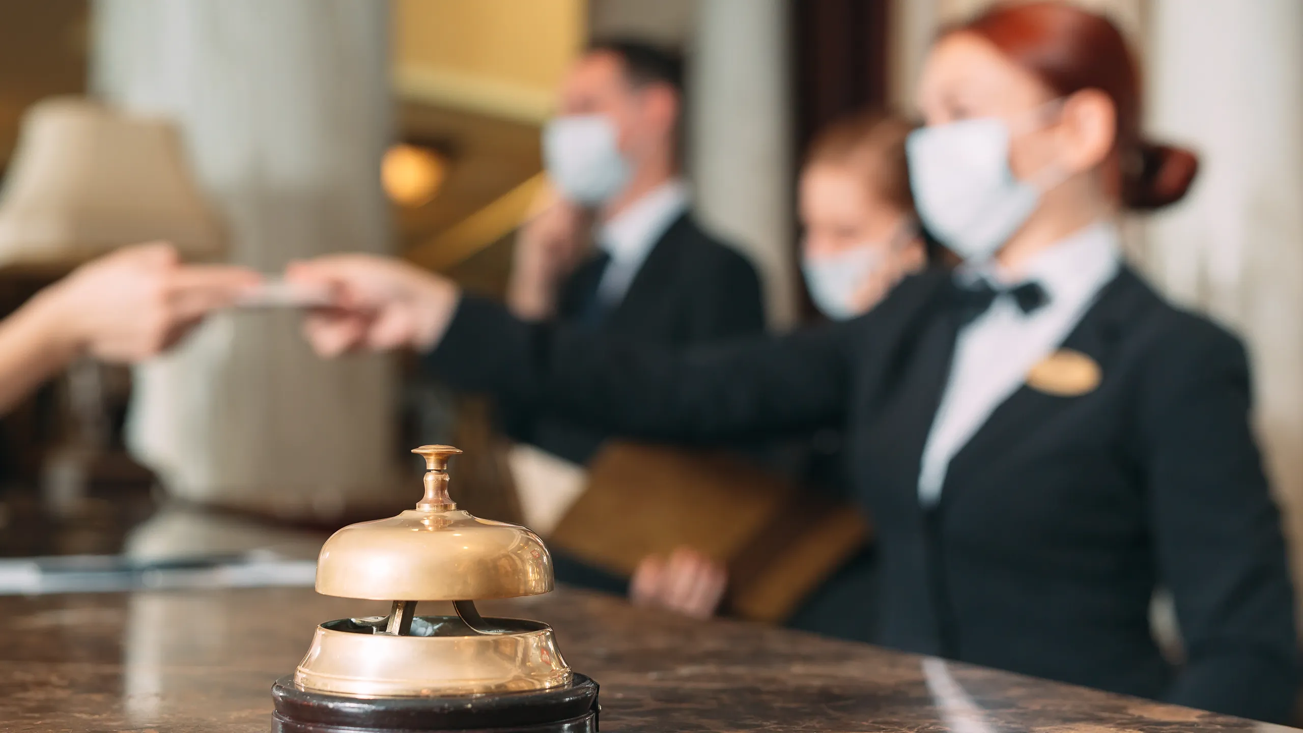 Check,In,Hotel.,Receptionist,At,Counter,In,Hotel,Wearing,Medical
