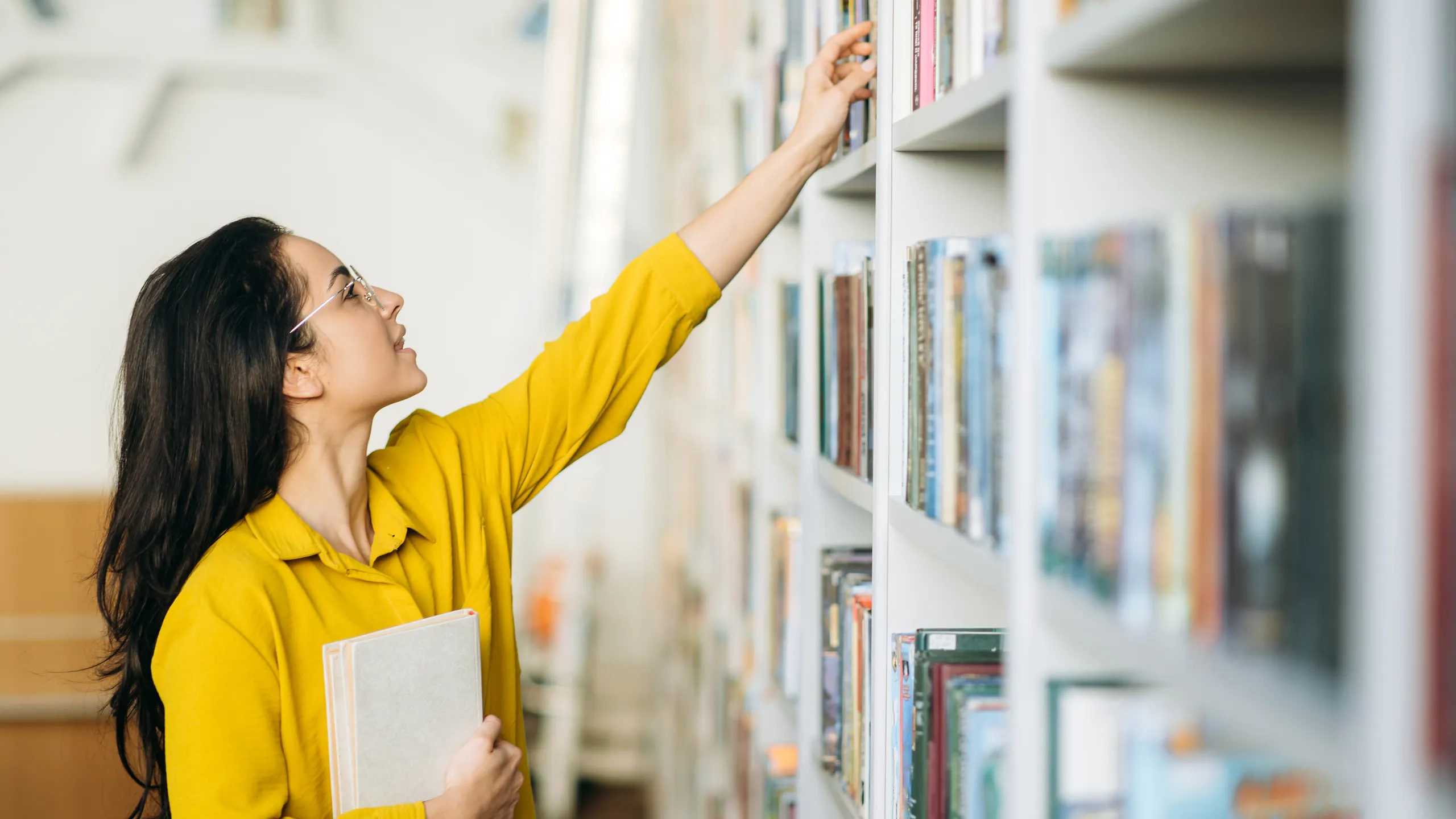 student picking books