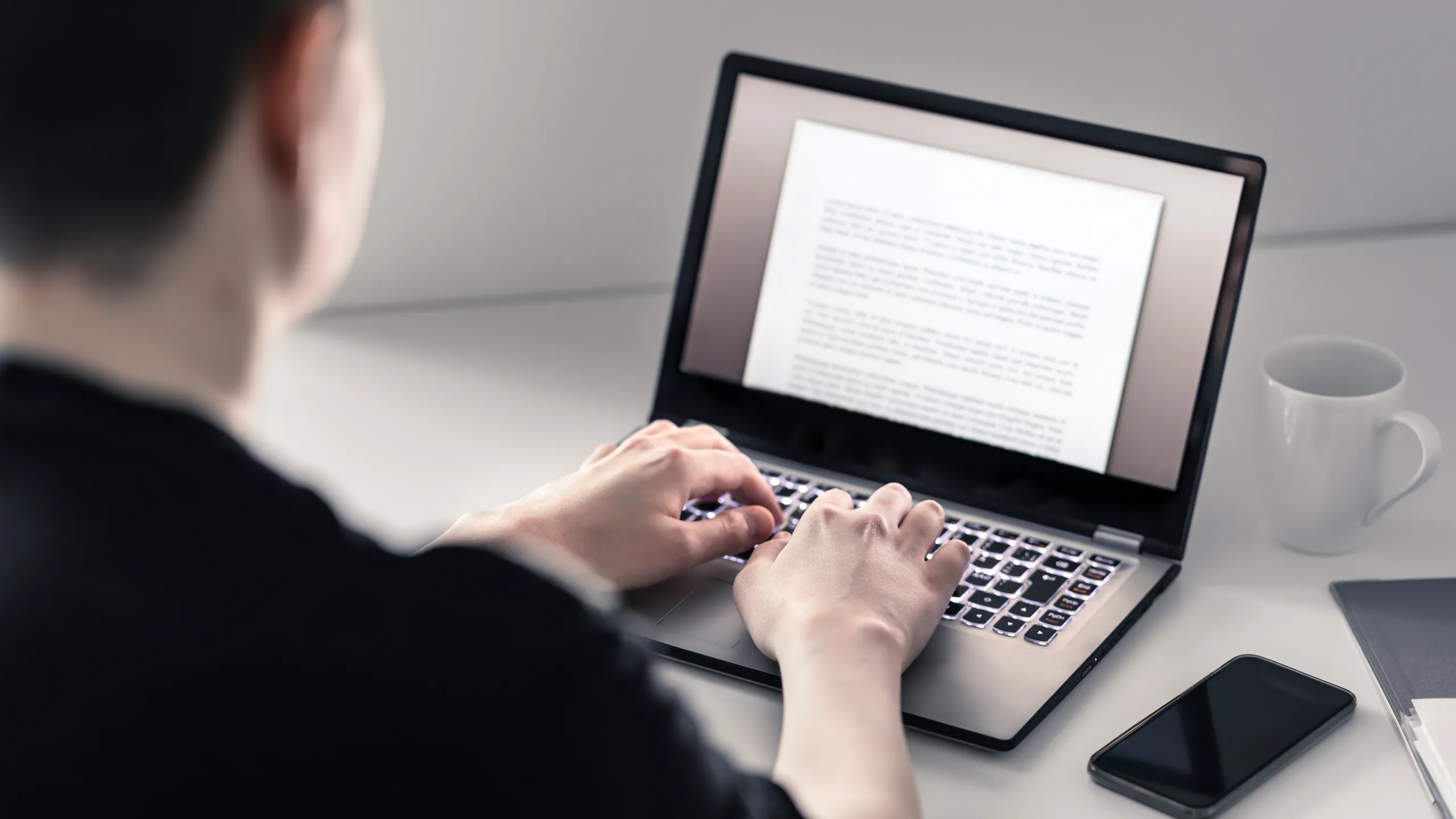 man writing on laptop