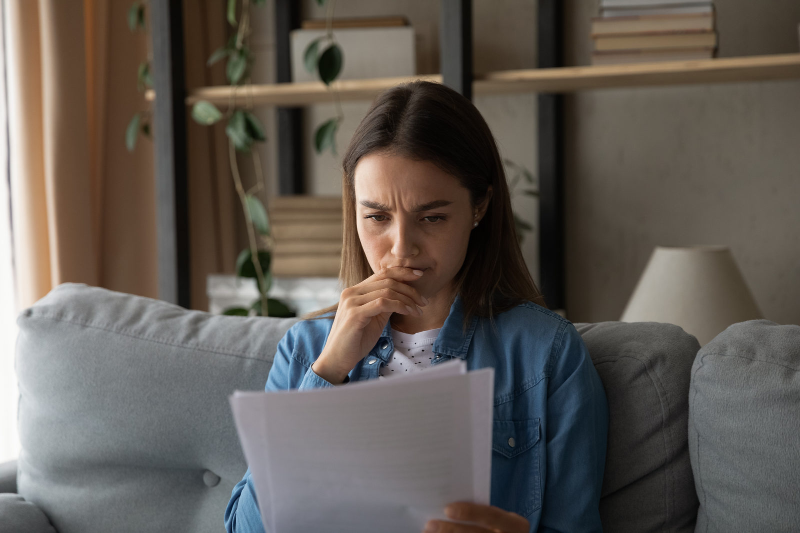 stressed female reading rejection letter