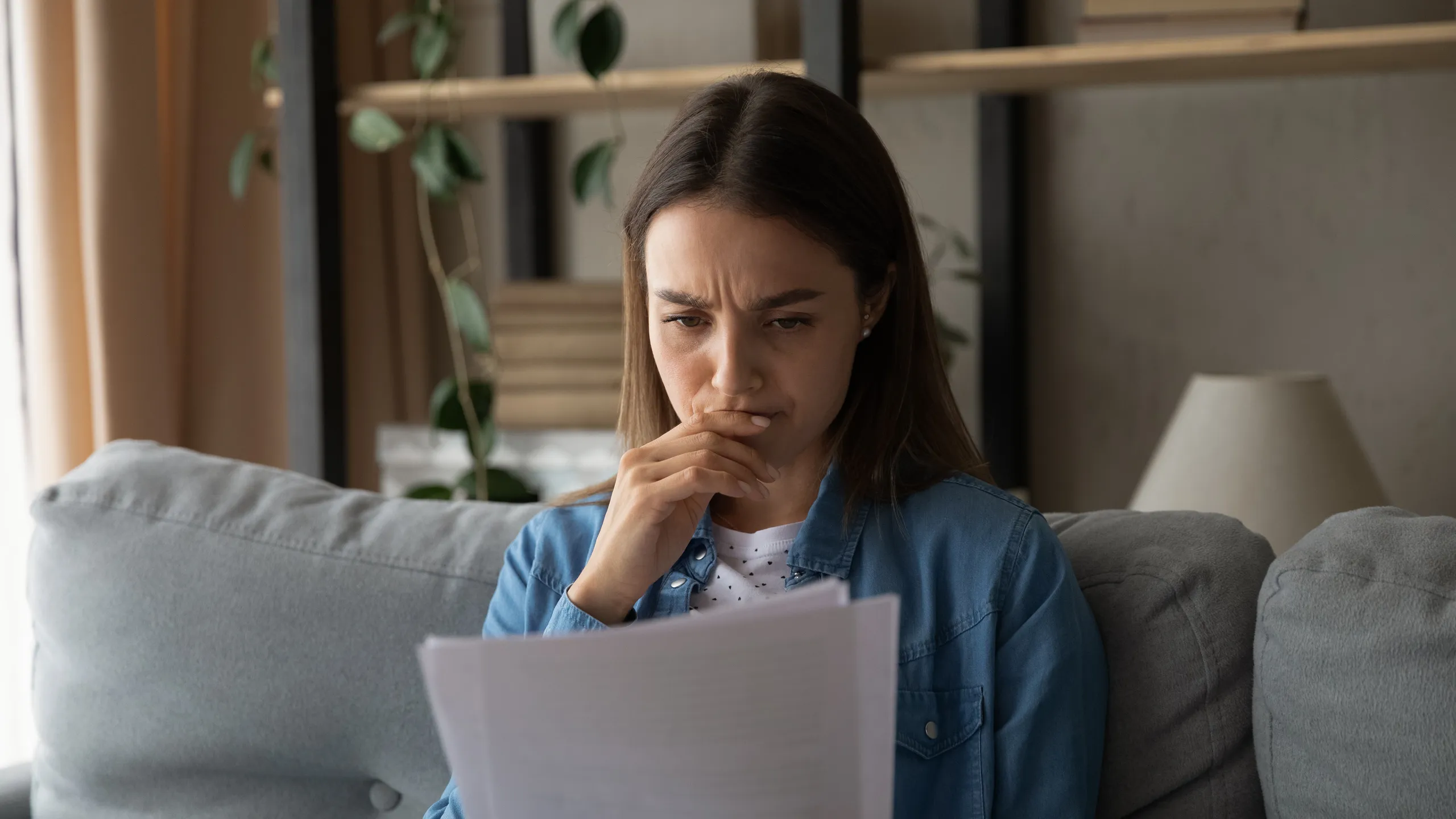 stressed female reading rejection letter
