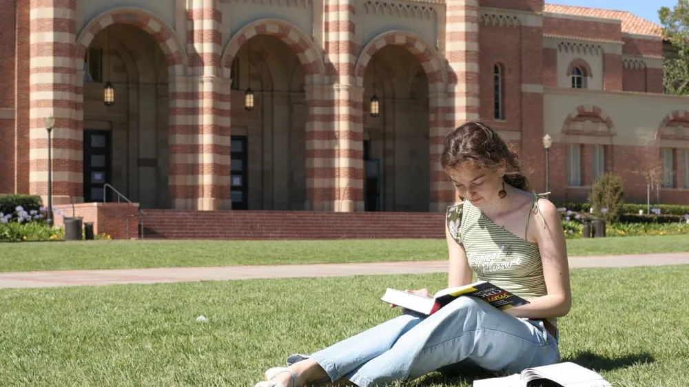 student studying on grass