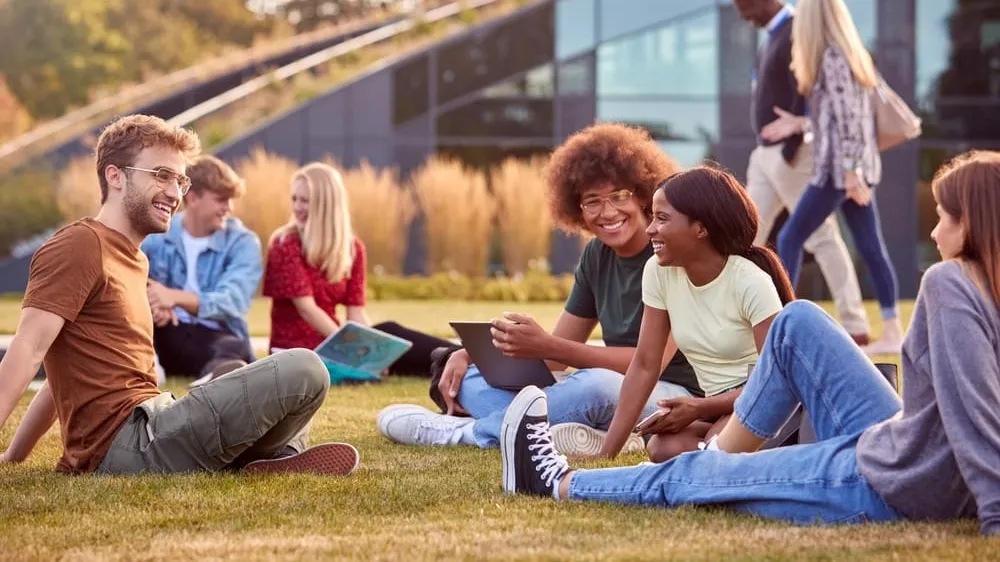 students working on grass on college campus