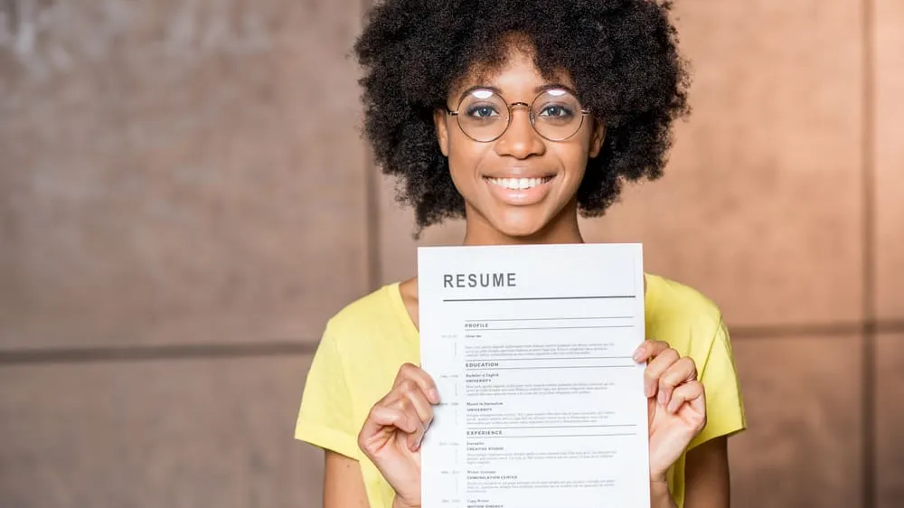 Young internship candidate shows student resume