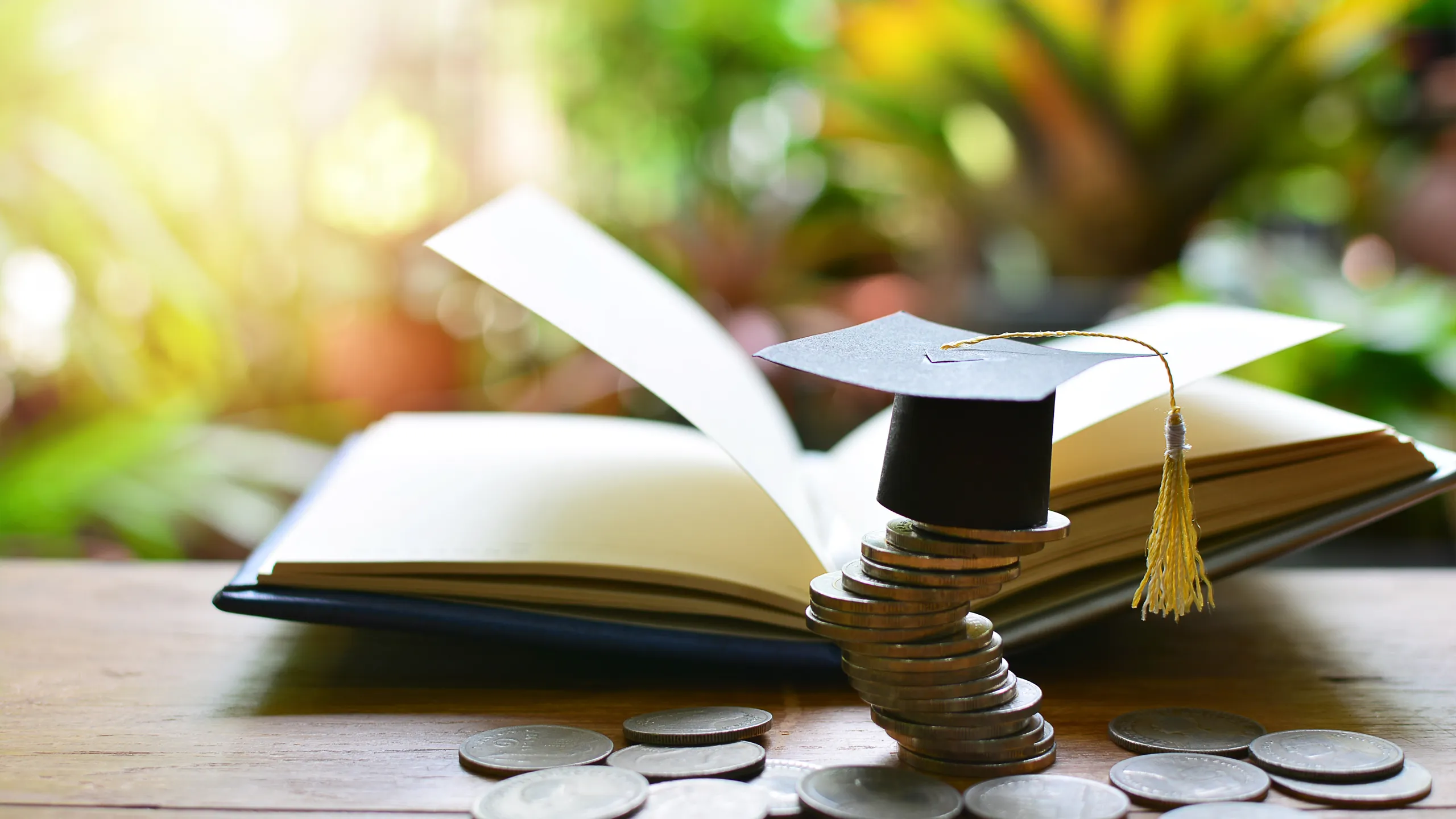 graduation cap and saving coins