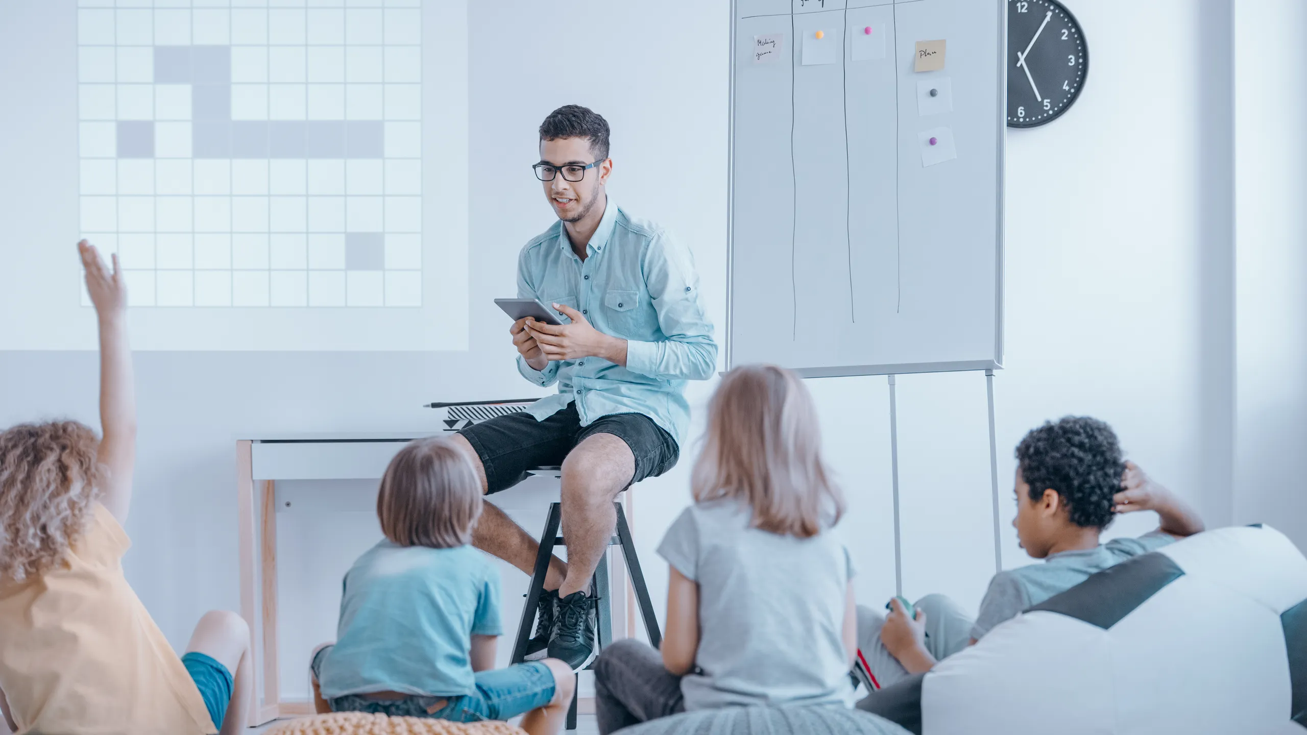 Student volunteering to tutor a classroom of children