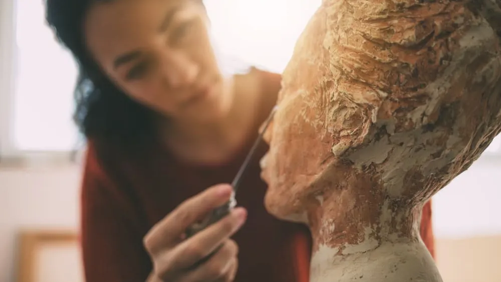 artist working on sculpture